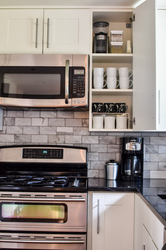 coffee mugs stored in a kitchen cabinets
