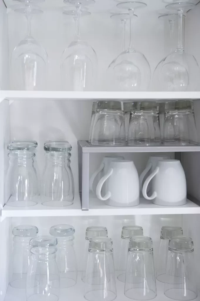 coffee mugs stored inside kitchen cabinet